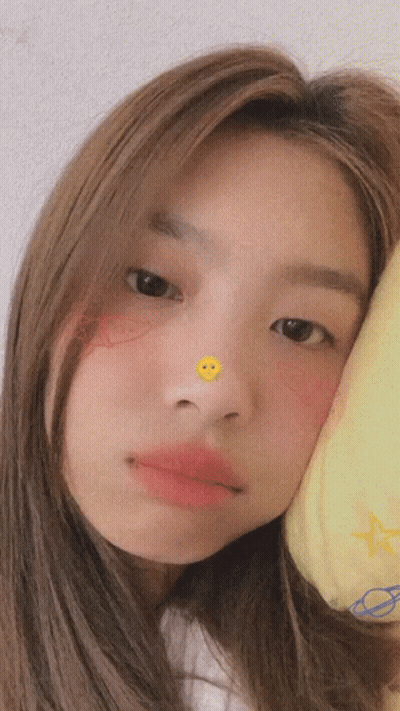 Girl Looking At Camera With Smiley Face On Nose GIF