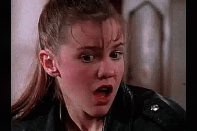 Girl Making Funny Face In Leather Jacket GIF