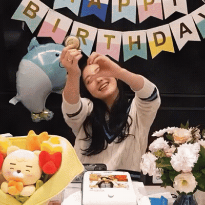 Girl Making Heart Hands Before Birthday Banner