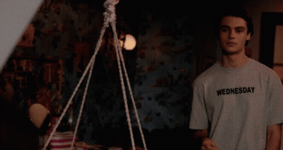Girl On Couch Next To Marvel Poster GIF