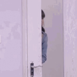 Girl Peeping On An Open Door GIF