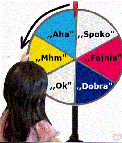 Girl Pointing At Colorful Spinning Wheel With Foreign Words GIF
