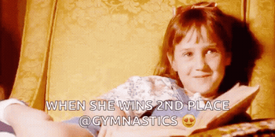 Girl Reading Book After Gymnastics Win GIF