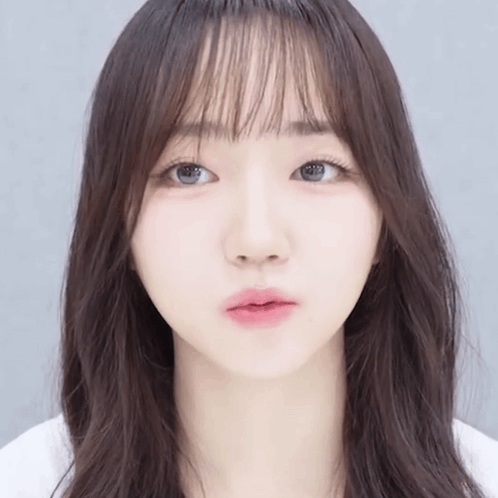 Girl's Face Close Up With Long Hair And Bangs GIF