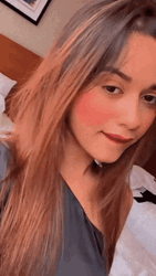 Girl Saying Mmm While Holding Chin GIF