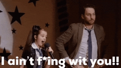 Girl Singing Into Microphone Beside Man In Suit GIF