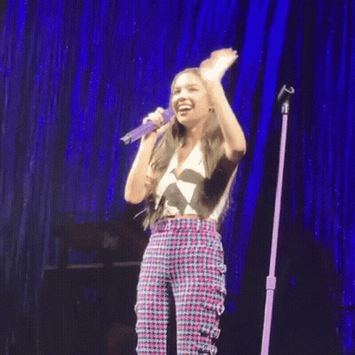 Girl Singing Into Microphone On Stage GIF