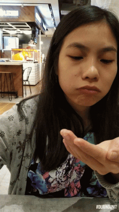 Girl Sitting At Table With #Duringunit Watermark GIF