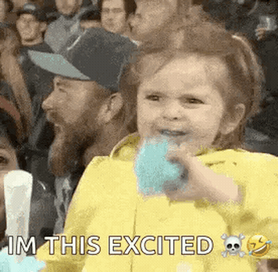 Girl Sitting In Crowd Eating Cotton Candy GIF