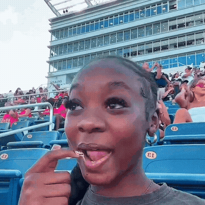 Girl Sitting In Stadium With Number 13 GIF