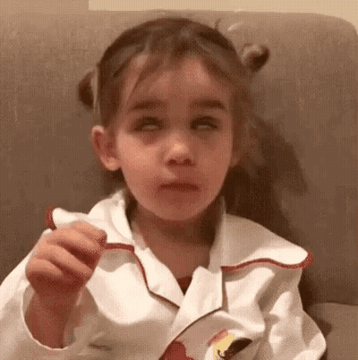 Girl Sitting On Couch Eating Candy GIF