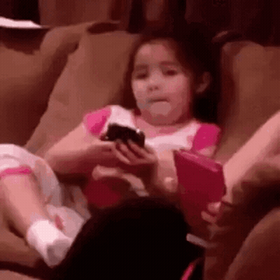 Girl Sitting On Couch Holding Phone GIF