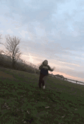 Girl Slipping On The Grass Field GIF
