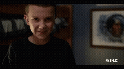 Girl Smiling In Front Of Netflix Ad GIF