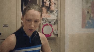 Girl Standing In Front Of Locker With Scoop Poster GIF
