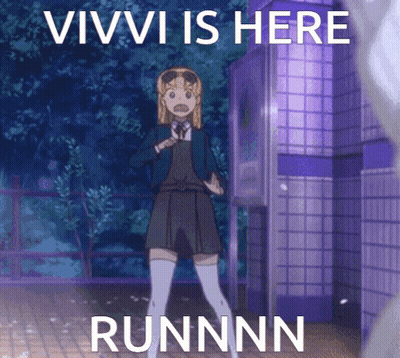 Girl Standing In Front Of Vivi Is Here Sign GIF