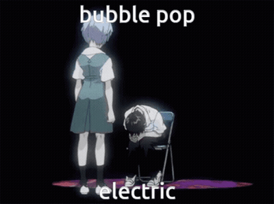 Girl Standing Next To Boy Sitting With Head On Hands GIF