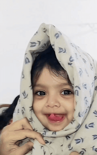 Girl Sticking Tongue Out With Blanket Over Head GIF