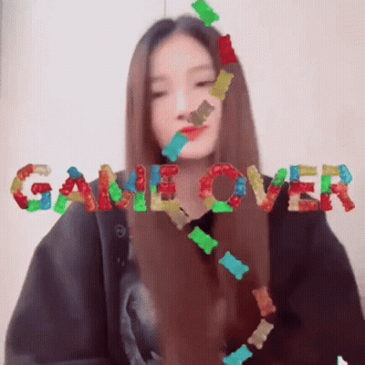 Girl Surrounded By Gummy Bears Saying Game Over GIF