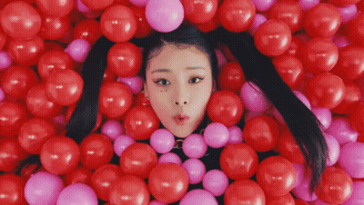 Girl Surrounded By Red And Pink Balloons GIF