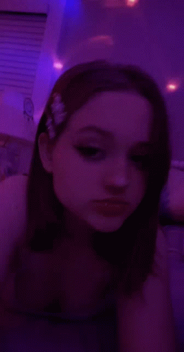 Girl Taking Selfie in Dark Room With Purple Lights