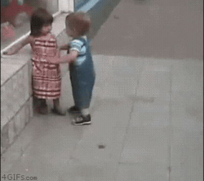 Girl Touching Boy's Face While Walking GIF