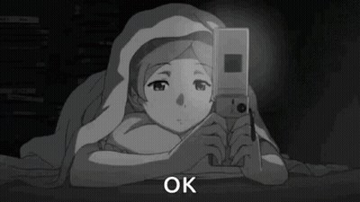 Girl Under Blanket Looking At Phone GIF
