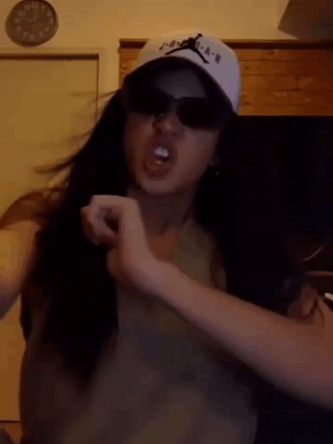 Girl Wearing Hat And Sunglasses Making Funny Face GIF