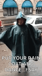 Girl Wearing Her Coat Dancing In The Rain GIF