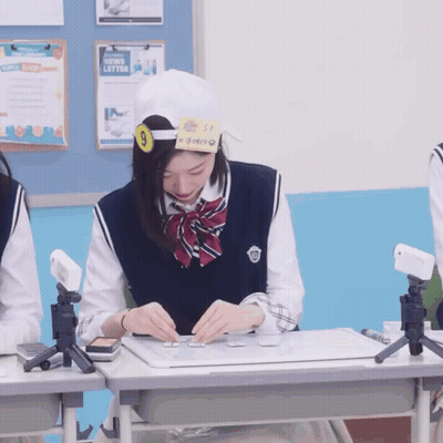 Girl Wearing Number 9 Sitting At Desk GIF