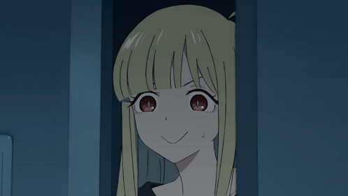 Girl With Blonde Hair And Black Shirt Smiling In Dark Room GIF