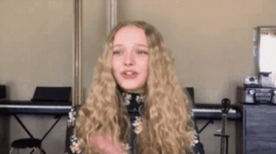 Girl With Blonde Hair Standing By Piano And Guitar GIF
