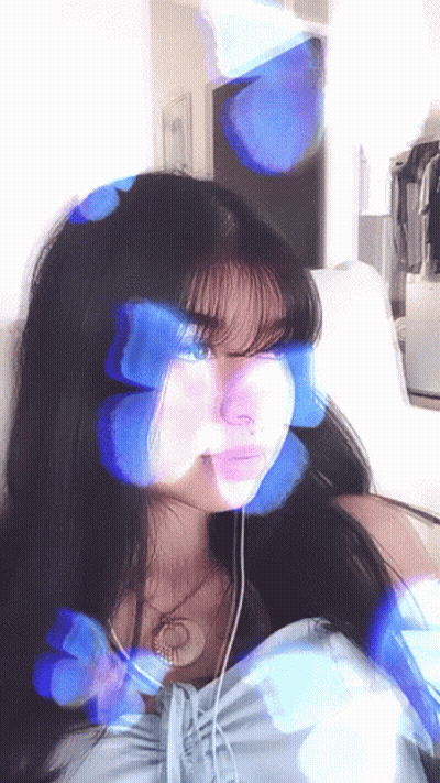 Girl With Blue Butterflies On Face Sitting On Couch GIF