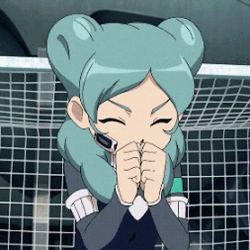 Girl With Blue Hair Covering Mouth In Front Of Soccer Net GIF