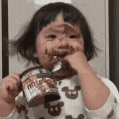 Girl With Chocolate Face Holding Nutella GIF