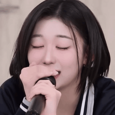 Girl With Eyes Closed Singing Into Microphone GIF