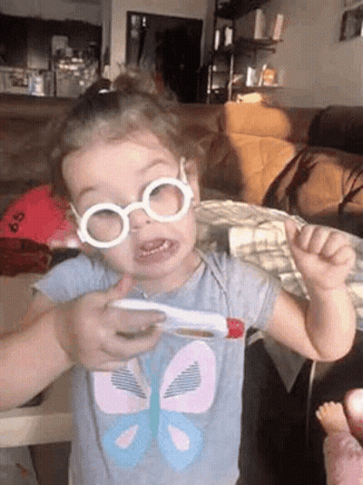 Girl With Glasses Holding Thermometer GIF