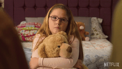 Girl With Glasses Hugging Teddy Bear Netflix Logo GIF