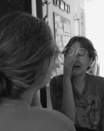 Girl With Glasses In Mirror GIF