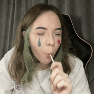 Girl With Green Hair Eating Lollipop With Star On Face GIF
