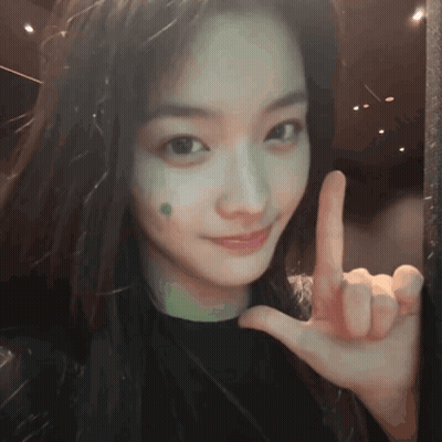 Girl With Green Spot Peace Sign GIF