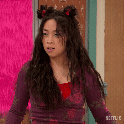 Girl With Hair Buns In Front Of Netflix Sign GIF