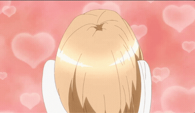 Girl With Hands On Face Surrounded By Pink Hearts GIF