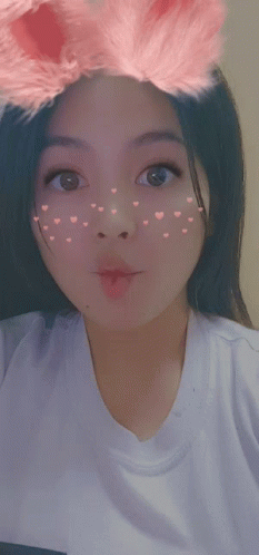 Girl With Hearts On Face In White T-Shirt GIF