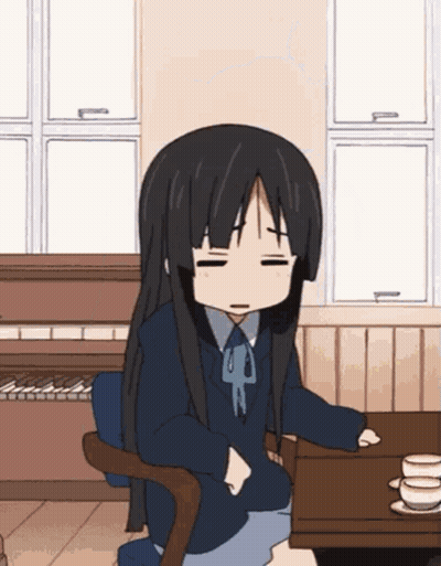 Girl With Long Black Hair Sitting With Eyes Closed GIF