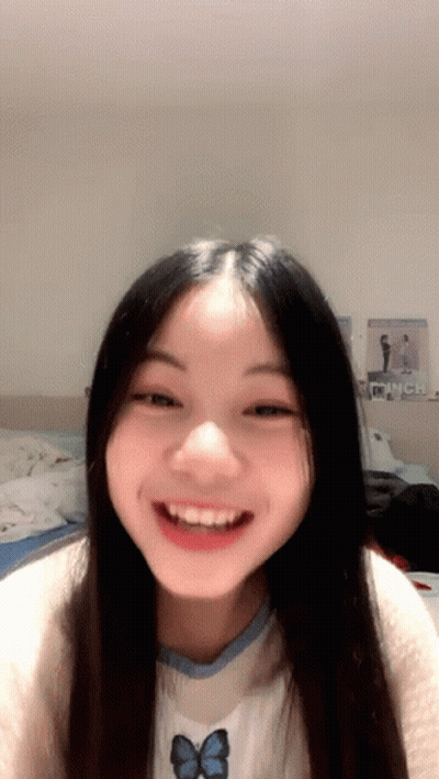 Girl With Long Black Hair Smiling In Butterfly Shirt GIF