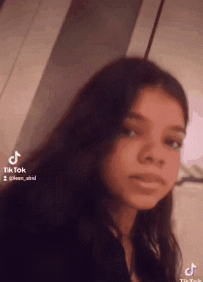 Girl With Long Dark Hair Looking at Camera