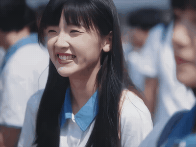 Girl With Long Hair And Blue Shirt Smiling GIF