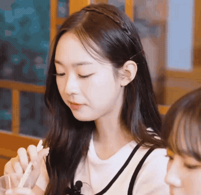 Girl With Long Hair Sitting At Table With Another Girl GIF