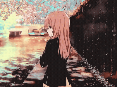 Girl With Long Hair Standing Near Water With Flowers GIF